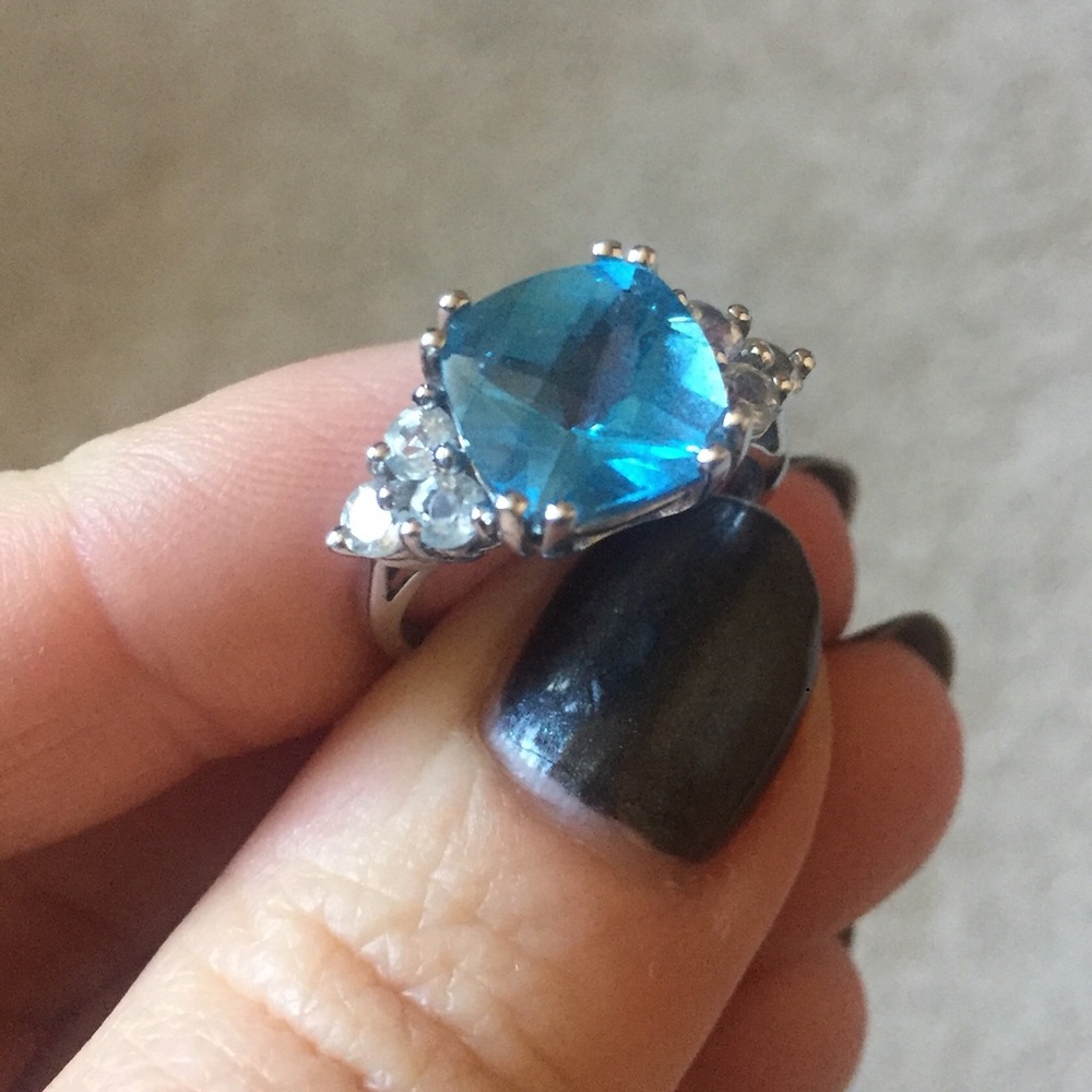 Blue topaz center w/ white sapphire accent ring.
